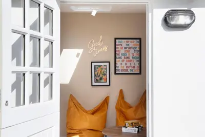 a hallway with a door and a sign on the wall at Beautifully refurbished cottage in lower Wivenhoe. in Wivenhoe