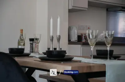 a dining room table with wine glasses on it at Luxury House By AR Properties Short Lets & Serviced Accommodation Colchester in Colchester