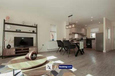 a living room with a table and a dining room at Luxury House By AR Properties Short Lets & Serviced Accommodation Colchester in Colchester