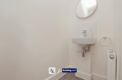 a bathroom with a sink and a mirror on the wall at Luxury House By AR Properties Short Lets & Serviced Accommodation Colchester in Colchester