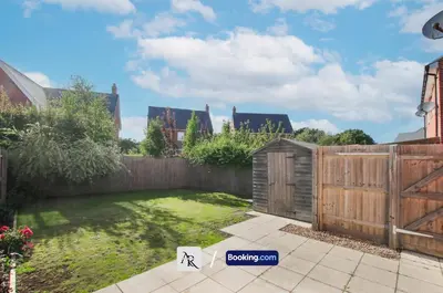 a garden with a fence and a wooden gate at Luxury House By AR Properties Short Lets & Serviced Accommodation Colchester in Colchester