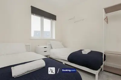 a bedroom with two beds and a window at Luxury House By AR Properties Short Lets & Serviced Accommodation Colchester in Colchester