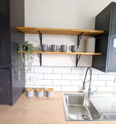 a kitchen with a sink and shelves on the wall at 3-Bed, Sleeps 6, 1 Bath, Parking, WiFi in Ipswich