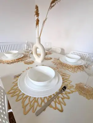 a table with plates and glasses and a vase on it at 3-Bed, Sleeps 6, 1 Bath, Parking, WiFi in Ipswich