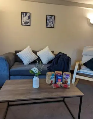 a living room with a couch and a coffee table at 3-Bed, Sleeps 6, 1 Bath, Parking, WiFi in Shalford