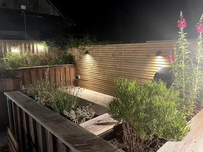 a garden with a wooden fence and some plants at Hall Farm Cottage, Barham in Ipswich
