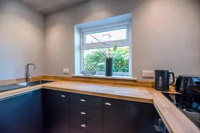 a kitchen with a sink and a window at Key Cottage, Orford in Woodbridge