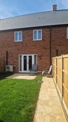 a brick house with a patio and a fence at Modern 2bedroom House in Ipswich Suffolk in Ipswich
