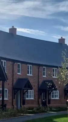 a large brick building with a black roof at Modern 2bedroom House in Ipswich Suffolk in Ipswich
