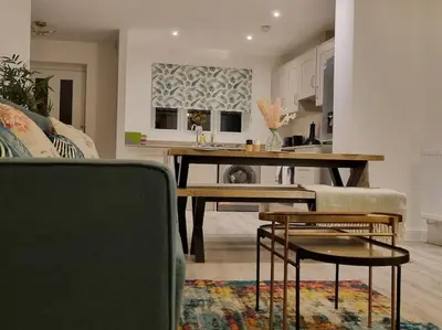 a living room with a table and a couch at Modern 2bedroom House in Ipswich Suffolk in Ipswich