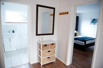 a bathroom with a mirror and a dresser in a room at Tillyard Retreat, Ground Floor Apartment Cambridge in Cherry Hinton