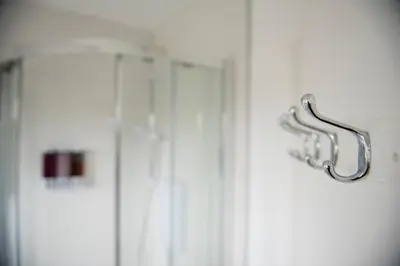 a doorhandle to a shower in a bathroom at Tillyard Retreat, Ground Floor Apartment Cambridge in Cherry Hinton
