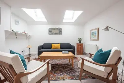 a living room with a couch and a table at Print Rooms, Leiston in Leiston