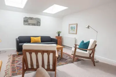 a living room with a couch and a chair at Print Rooms, Leiston in Leiston