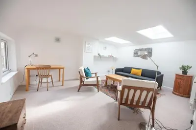 a living room with a couch and a table at Print Rooms, Leiston in Leiston