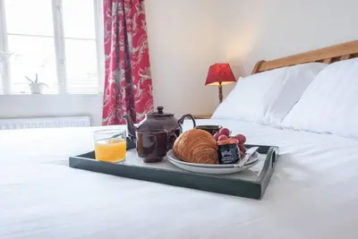 a tray with a breakfast of coffee and croissants on a bed at The Little Hopton, Saxmundham in Saxmundham