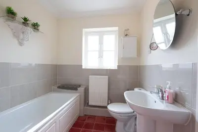 a bathroom with a tub and a toilet and a sink at The Little Hopton, Saxmundham in Saxmundham