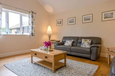 a living room with a couch and a coffee table at Grove Farm Bungalow and Annexe, Dallinghoo in Woodbridge