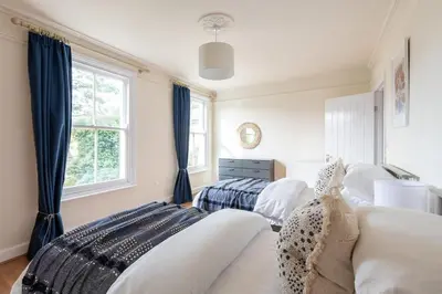 a bedroom with two beds and a window at Peaceful Oasis 3 Beds House with Garden and Parking in Cambridge