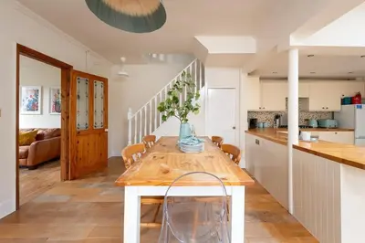 a kitchen with a wooden table with a vase on it at Peaceful Oasis 3 Beds House with Garden and Parking in Cambridge
