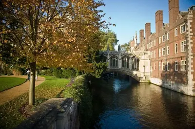 a bridge over a river in front of a building at Peaceful Oasis 3 Beds House with Garden and Parking in Cambridge