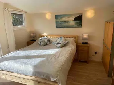 a bedroom with a bed with two pillows on it at Ferncroft Garden Studio in Histon