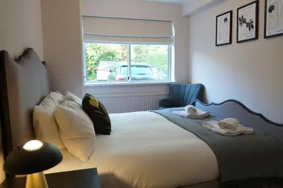 a bedroom with a bed with towels on it at Lady Jane Court in Trumpington