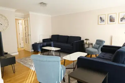 a living room with blue couches and chairs at Lady Jane Court in Trumpington
