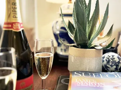 a bottle of wine and a potted plant on a table at Dell View by The Suffolk Cottage Collection in Bentley