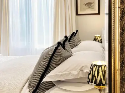a bedroom with a bed with black and white pillows at Dell View by The Suffolk Cottage Collection in Bentley