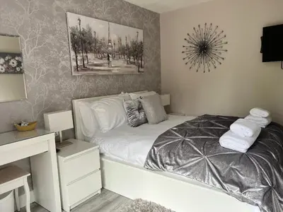 a small bedroom with a white bed and a desk at Kings head Inn in Stutton