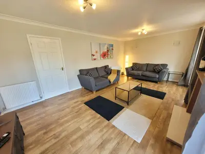 a living room with two couches and a table at Modern 4-Bedroom Contractor Base in Lexden with Parking, WiFi & Quick Access to Sites- Catchpole Stays in Lexden