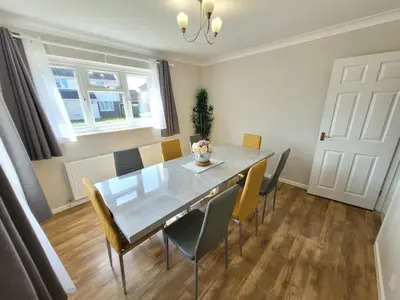 a dining room with a glass table and chairs at Modern 4-Bedroom Contractor Base in Lexden with Parking, WiFi & Quick Access to Sites- Catchpole Stays in Lexden