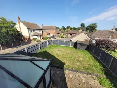 a view from the balcony of a house with a yard at Modern 4-Bedroom Contractor Base in Lexden with Parking, WiFi & Quick Access to Sites- Catchpole Stays in Lexden