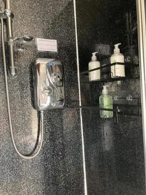 a bathroom with a shower with a soap dispenser at Home from Home in our Self-Contained Annexe in Radwinter