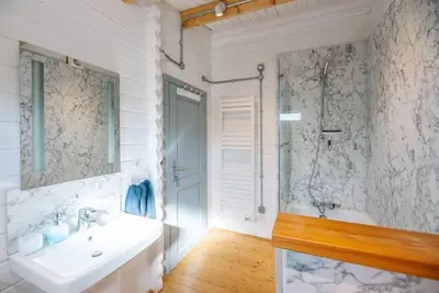 a white bathroom with a sink and a shower at The Cabin, Parham in Woodbridge