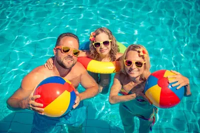 a group of people in a swimming pool holding beach balls at Great Caravan On A Family Holiday Park In Essex, Ref 37055G in Clacton-on-Sea