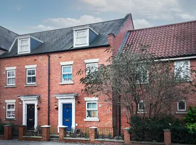 a red brick house with a blue door at Entire House in Ipswich - Handford in Ipswich