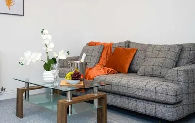 a living room with a couch and a glass table at Entire House in Ipswich - Handford in Ipswich