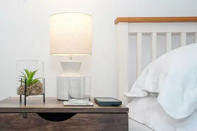 a lamp on a table next to a bed at Entire House in Ipswich - Handford in Ipswich