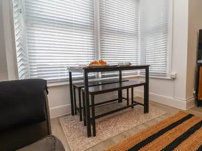 a table in front of a window with a plate of food on it at 11a Manning Road in Felixstowe