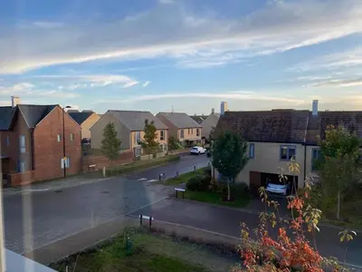 a view of a residential neighbourhood with houses and a street at Homely, Cosy & Contemporary 4 BDR house with Garden & Parking 5 mins drive to Addenbrookes & Papworth hospitals & Bio Medical campus in Cambridge