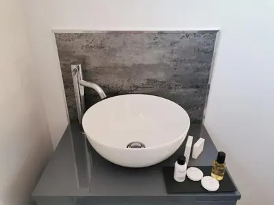 a bathroom with a white sink on a table at Woodpeckers - Alresford Essex in Alresford