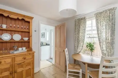 a kitchen with a table and chairs and a window at Victorian 2 Bedroom Home near the river Cam in Cambridge