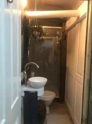 a bathroom with a sink and a toilet at Cosy hideaway with garden sauna in Cambridge in Cambridge