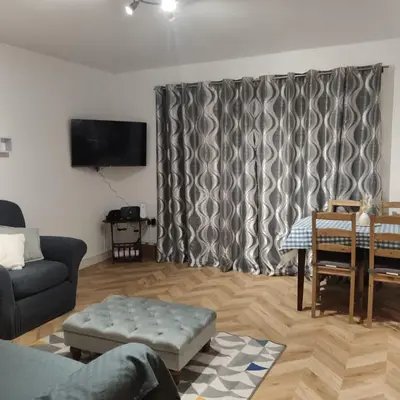 a living room with a couch and a table at Ratcliffe Apartment in Colchester
