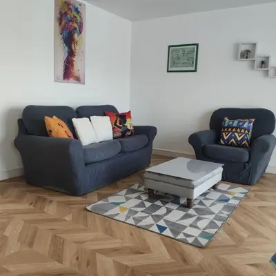 a living room with two couches and a coffee table at Ratcliffe Apartment in Colchester