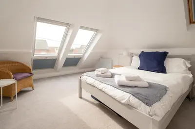 a bedroom with a bed with towels on it at Pantiles in Aldeburgh