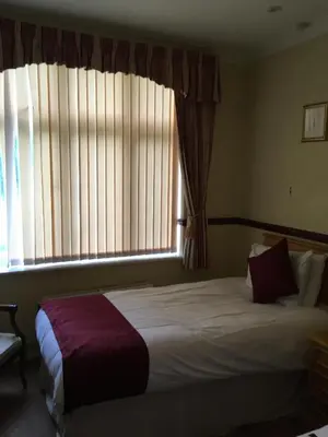 a bedroom with a large bed and a window at Nyton Hotel in Ely