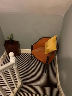 a room with a bed with a yellow pillow on it at Elegant Luxury City Centre Apartment on On Mill Rd - Walk to Station and City Centre in Cambridge
